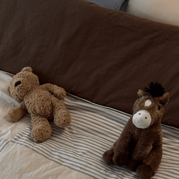 Plush toys resting on soft bedding